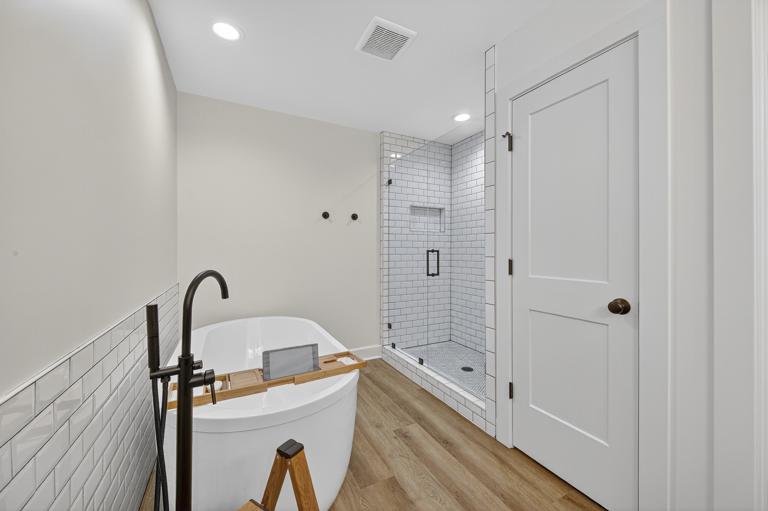 Spa-inspired bathroom with a freestanding soaking tub, walk-in shower, and timeless subway tile detailing for a truly relaxing experience.