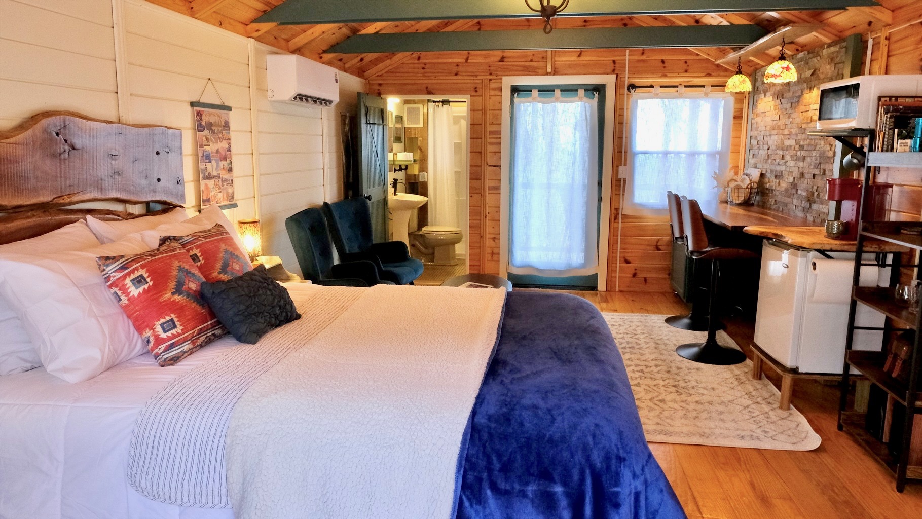 Everything you need in your Cabin, Queen Bed, Bathroom, Kitchenette, Seating and Dining Areas.