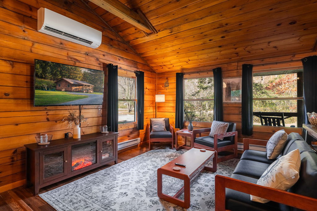 Relax in the inviting living room with a 55" smart TV, plush seating, and an electric fireplace for cozy evenings in.