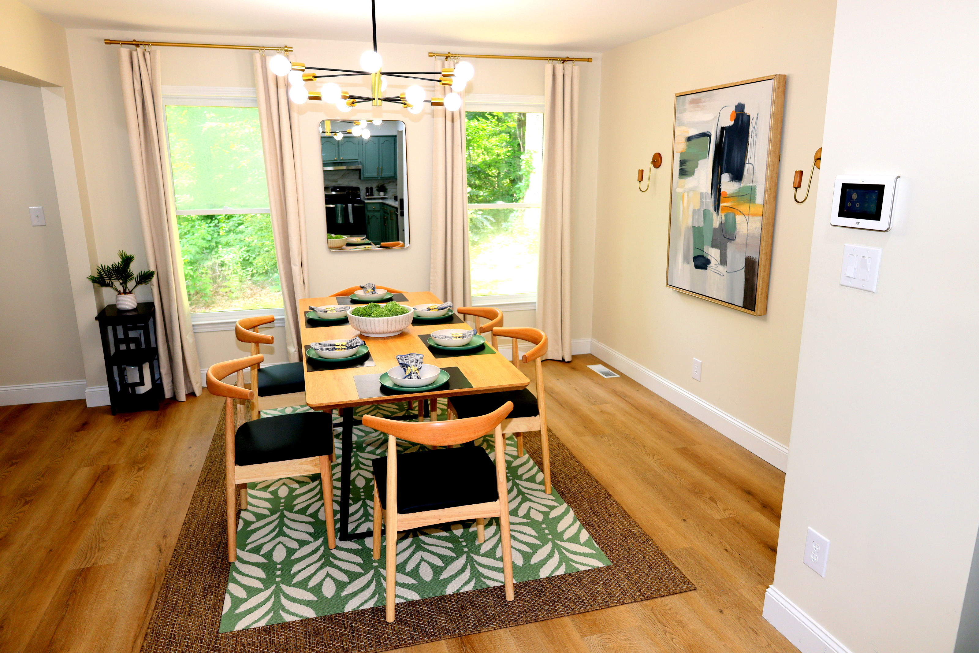 Bright dining area with seating for group meals, modern lighting, and stylish table settings