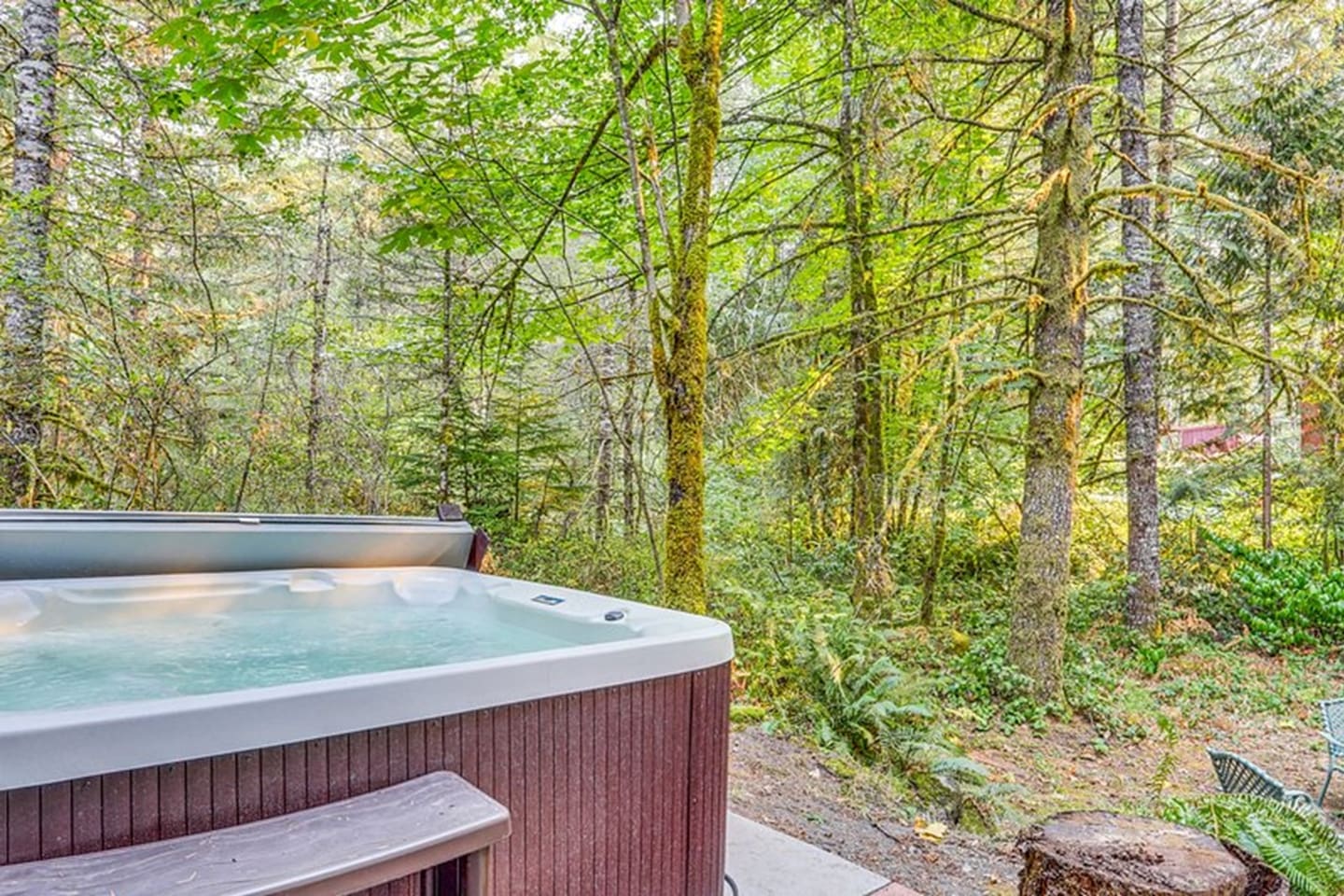 Covered hot tub looks out to our  acres and acres of wooded property.