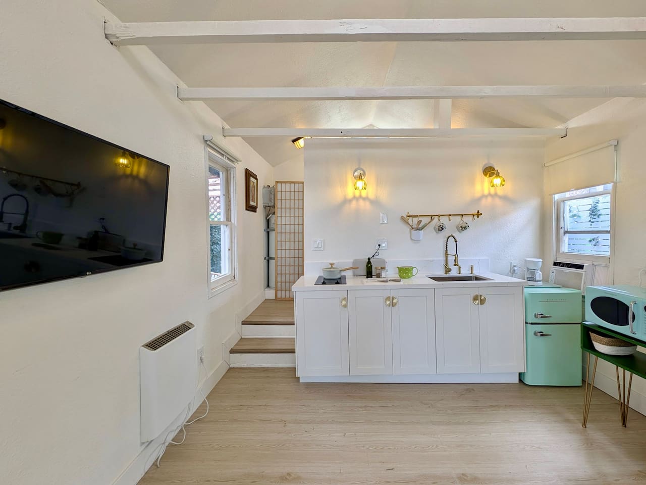 Open-concept studio with kitchenette and Smart TV.