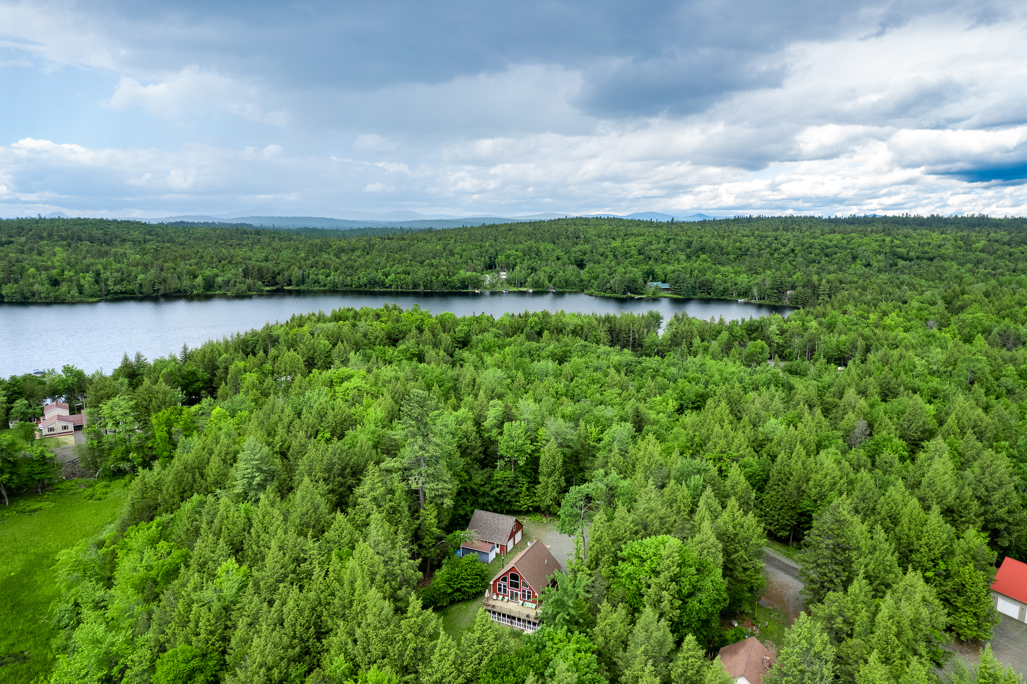 Private lake access with a dock in protected cove, large parking area, large backyard, quiet surroundings.