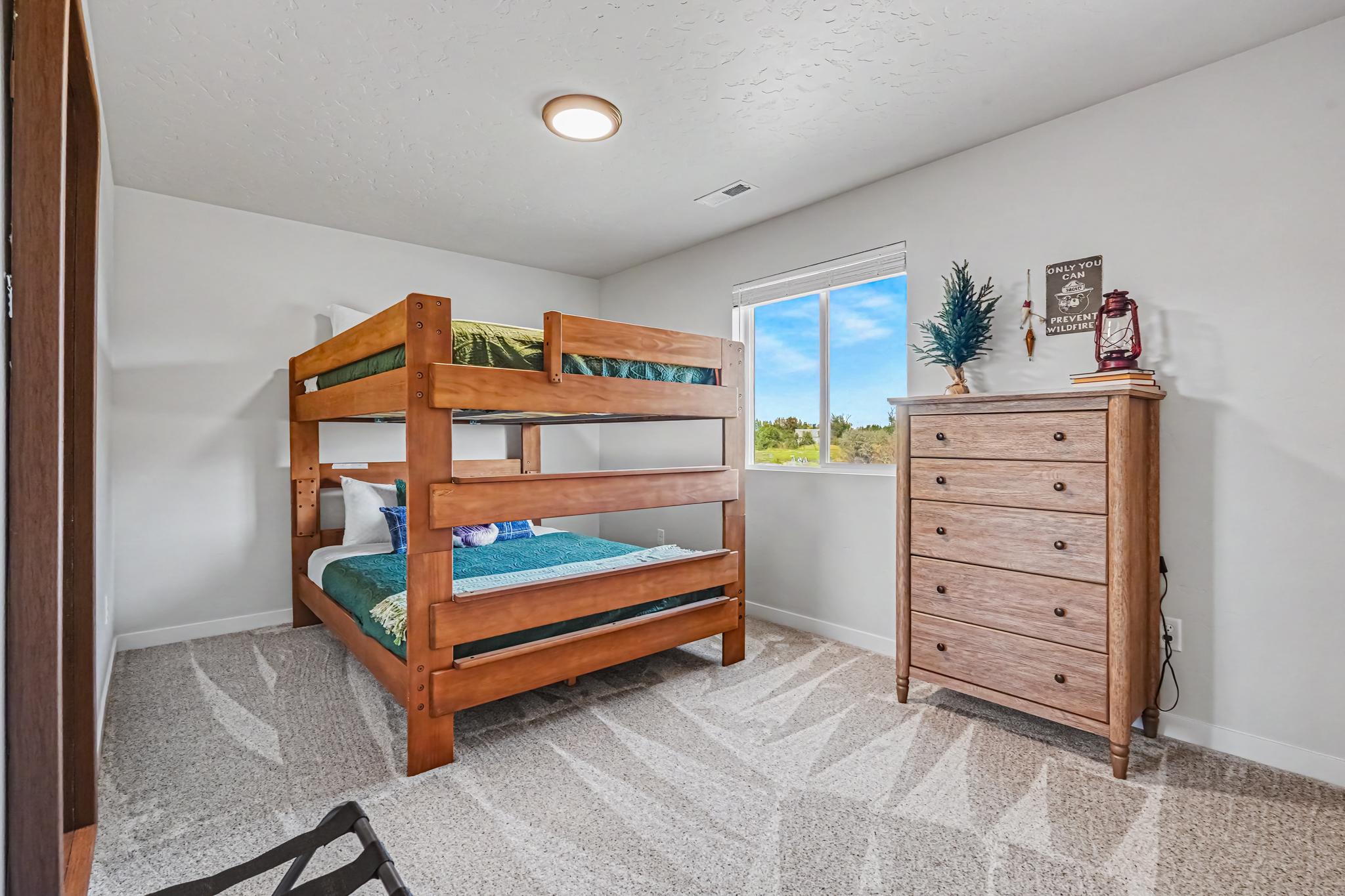 The third upstairs bedroom is oversized with a queen-over-queen bunk bed.  