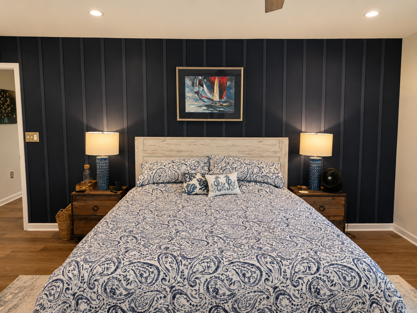 Main-floor primary bedroom with a king bed, cozy lighting and a calm, comfortable layout.