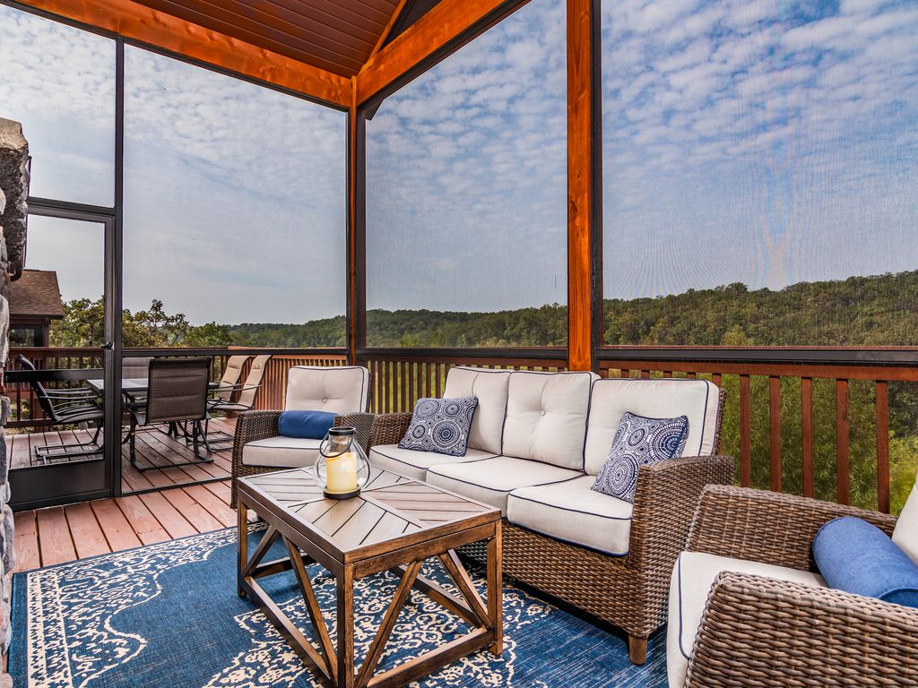 Screened in deck that has a fireplace AND tv!
