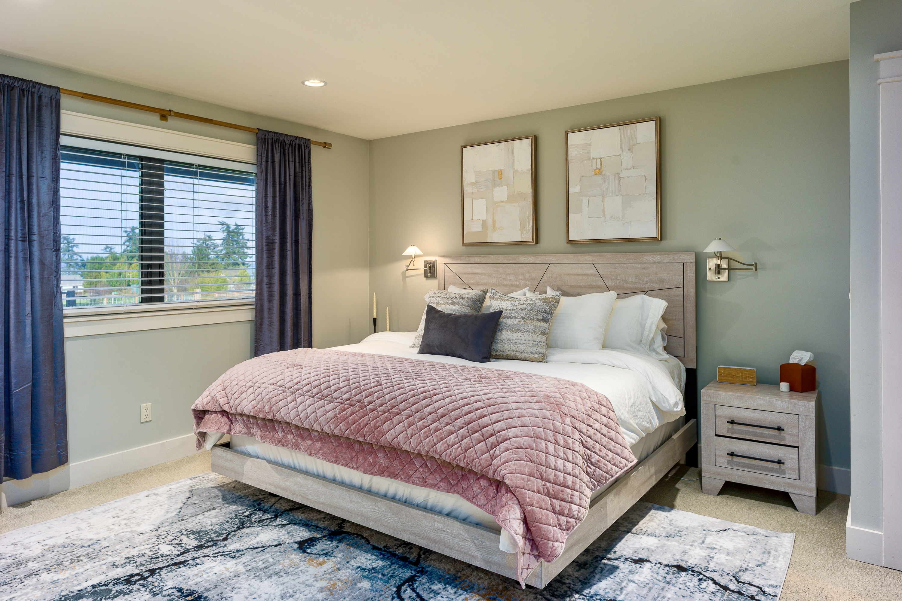 The larger primary bedroom with king-sized bed and ensuite bathroom invites you to rest and recharge. 