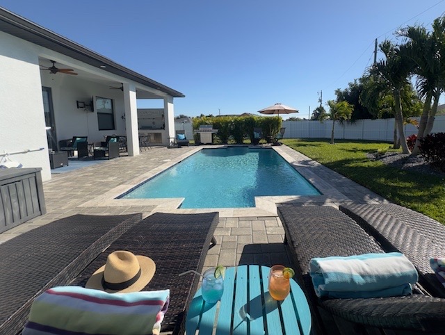 Soak up the Florida sunshine or bask in the shade with our oversized umbrella beside the pool!