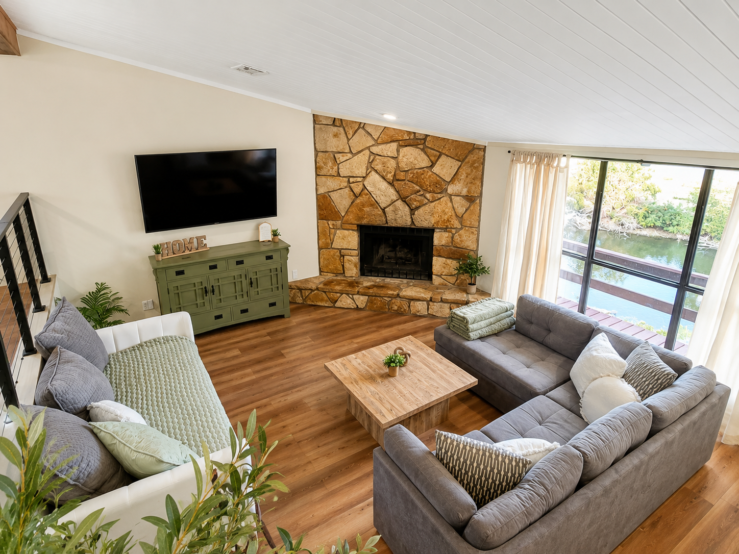 Open living room with fireplace and panoramic lake views.