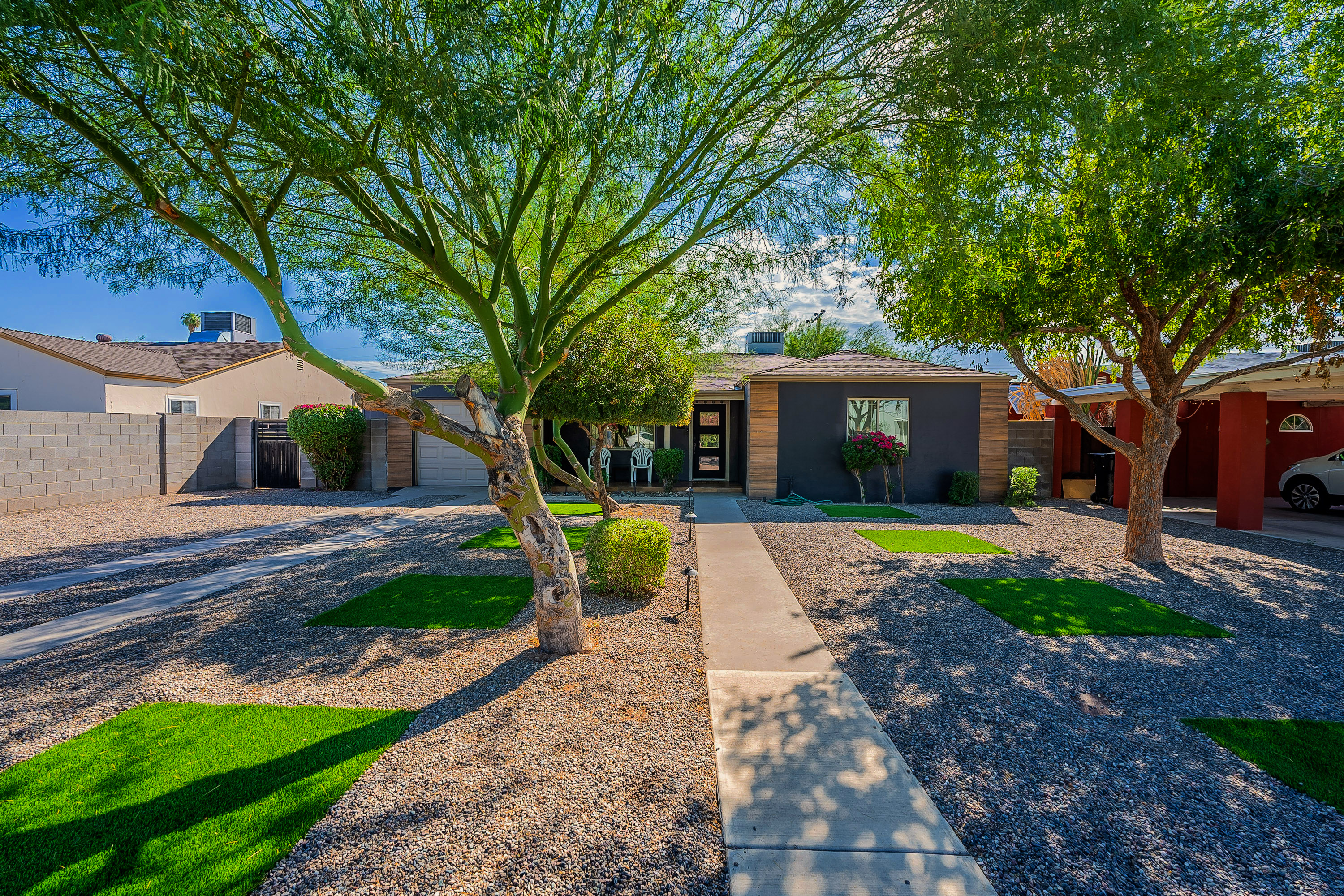 Exterior Oasis: Embrace the sunshine in this vibrant, landscaped retreat in Phoenix!