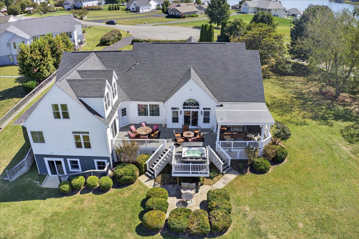 Memories to be made on vacation, in the backyard retreat with hot tub, covered porch, and open-air seating.