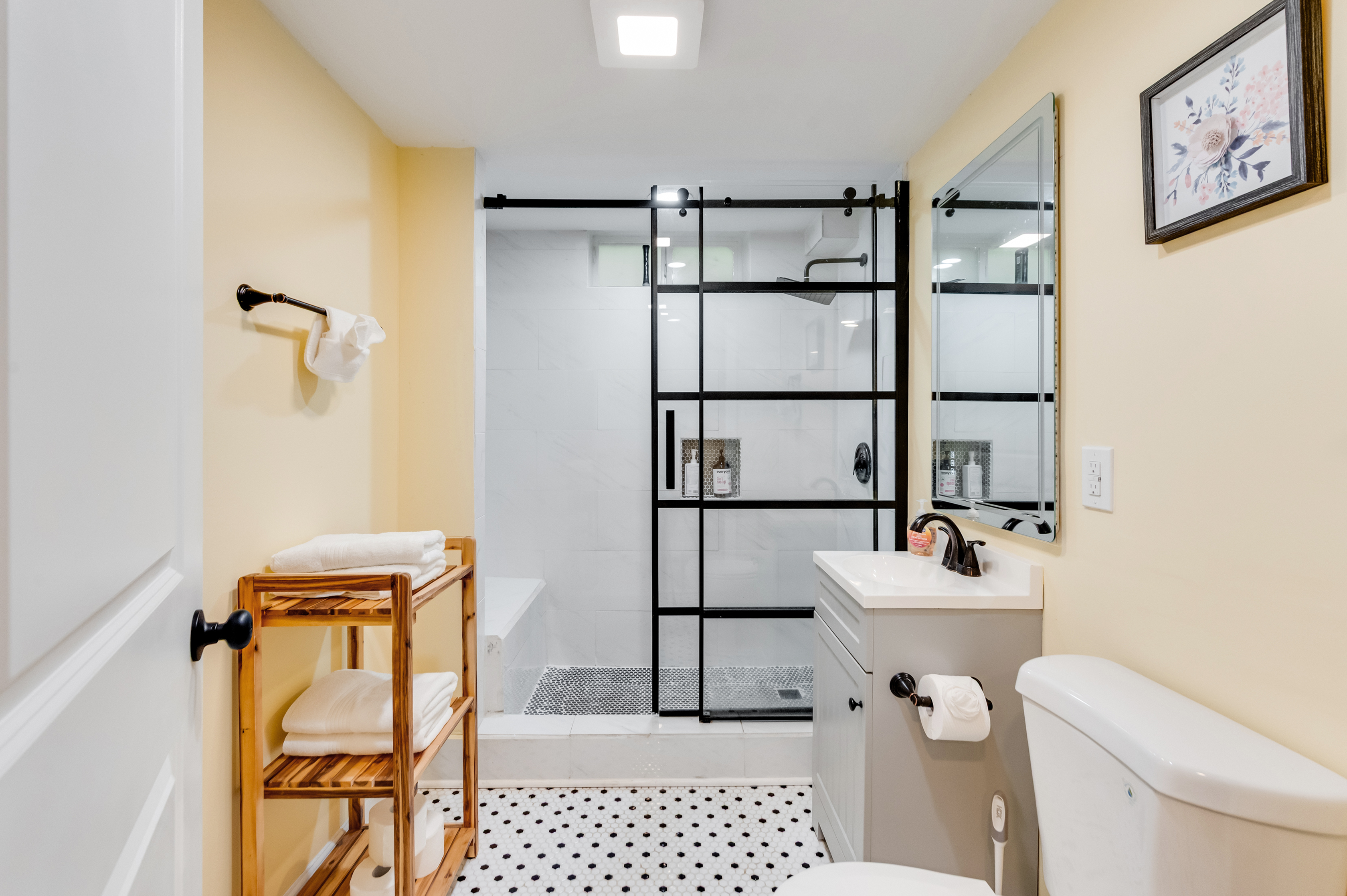 Downstairs Bathroom 3: Elegant space with sleek glass shower and stylish decor for a refreshing escape!