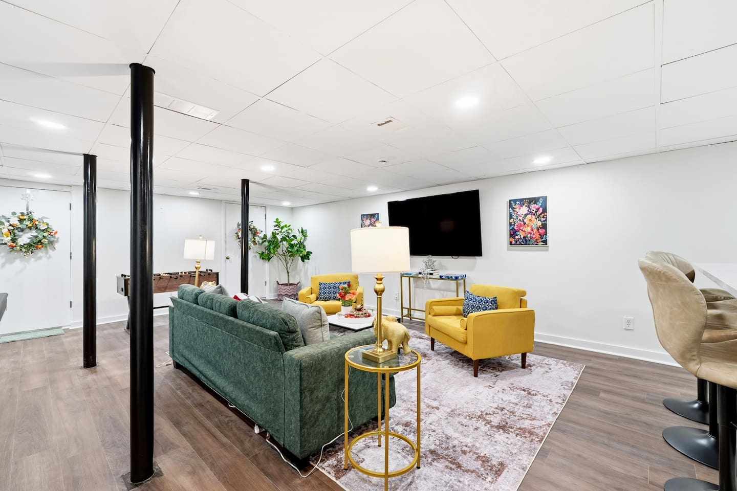 Amazing game room located in the basement, featuring a pool table, foosball table, and a stylish bar perfect for entertaining and relaxing with friends and family.