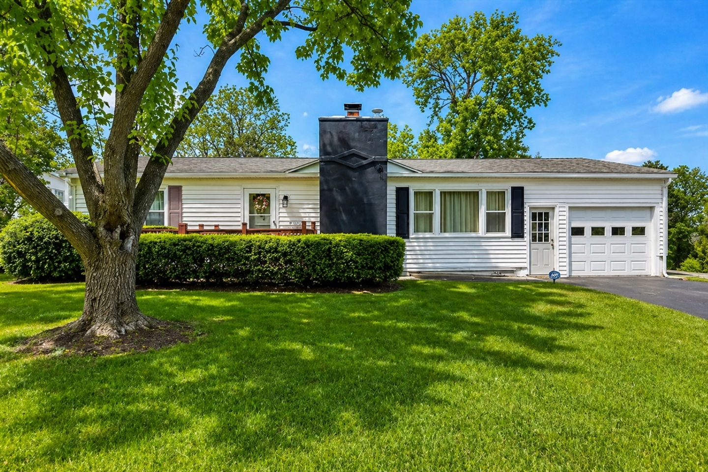 Discover the charm of this cozy lakeside home, nestled among mature trees and offering a tranquil escape with a classic touch.
