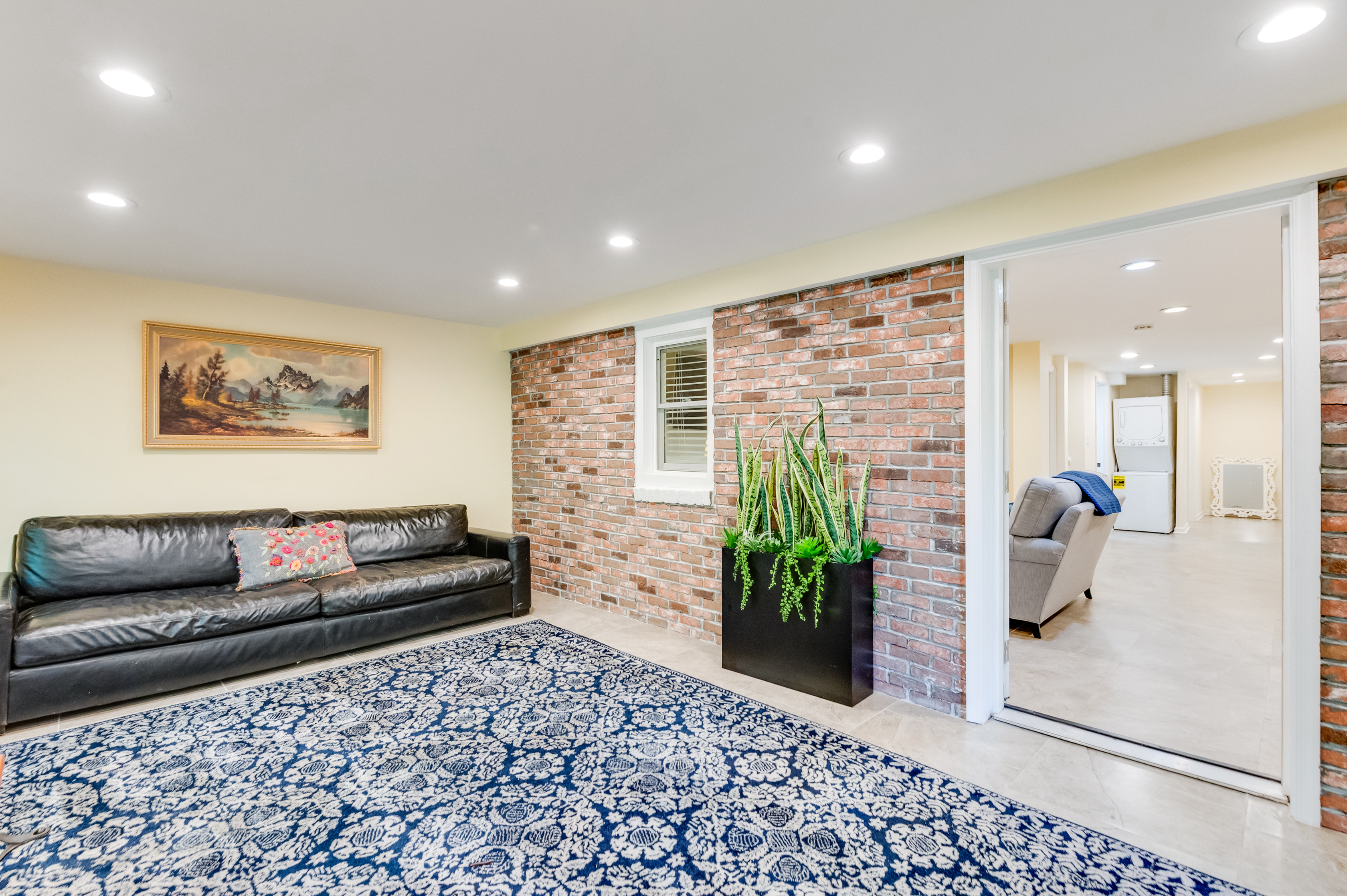 Downstairs Sun Room: Enjoy stylish leather seating and vibrant decor in this inviting hangout space!