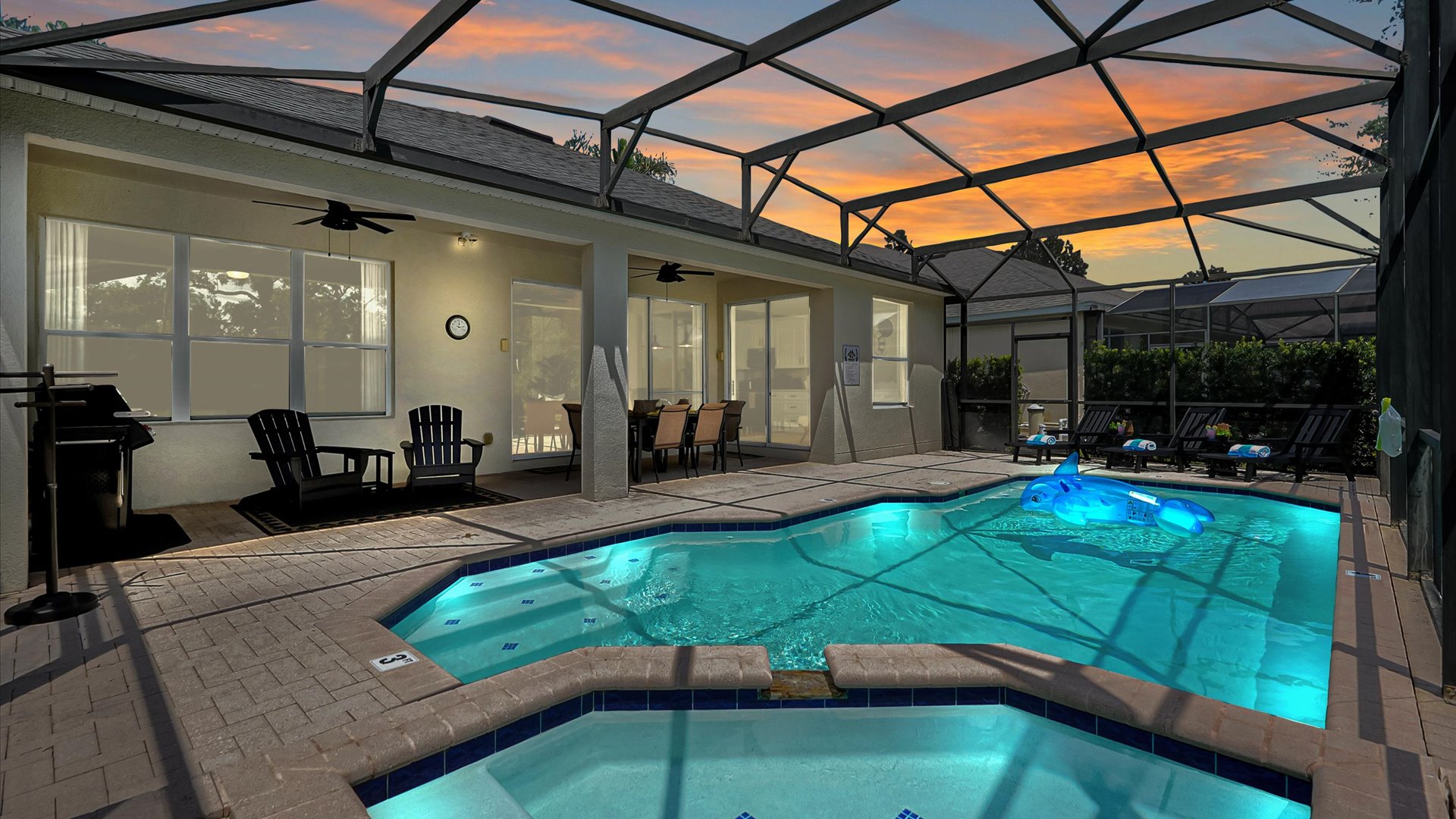 Evening Pool: Unwind beside the illuminated private pool and spa beneath a beautiful Florida sunset.