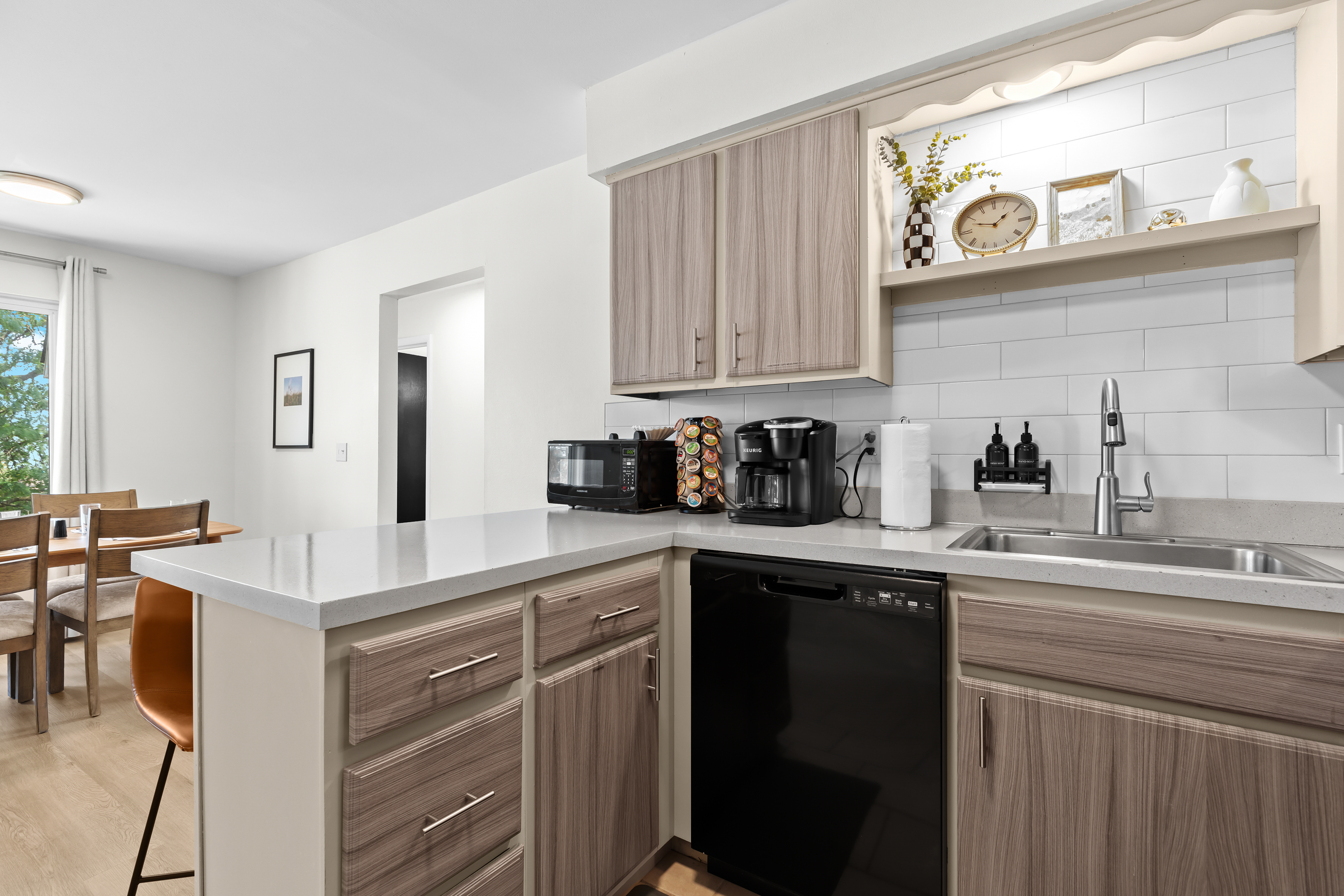 Functional kitchen with stylish cabinetry, bar seating, and all the essentials for cooking.