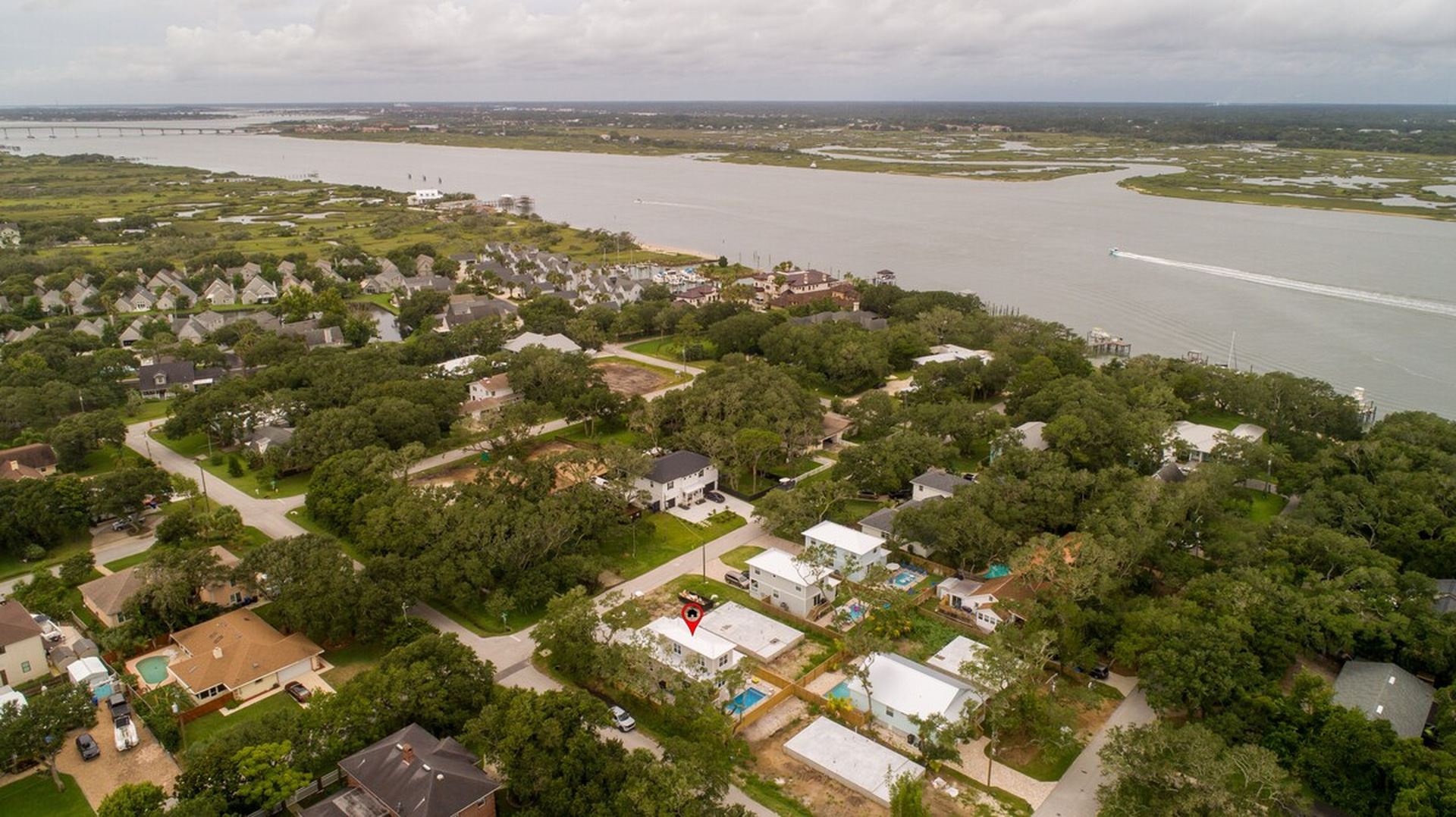 Turn the other way and the Intracoastal opens up: the Tolomato River, the marsh grass, and boats running south toward the bridge. Sunset over this water is well worth the few minutes it takes to walk down to it.