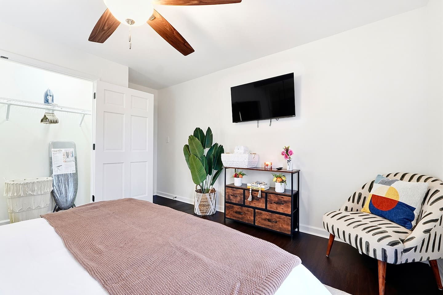 Upstairs bedroom located to the right, featuring a floral-inspired design and a comfortable double bed. Includes a smart TV and easy access to a shared bathroom. This room includes 2 full-body towels, 2 washcloths, and 2 hand towels for your stay.