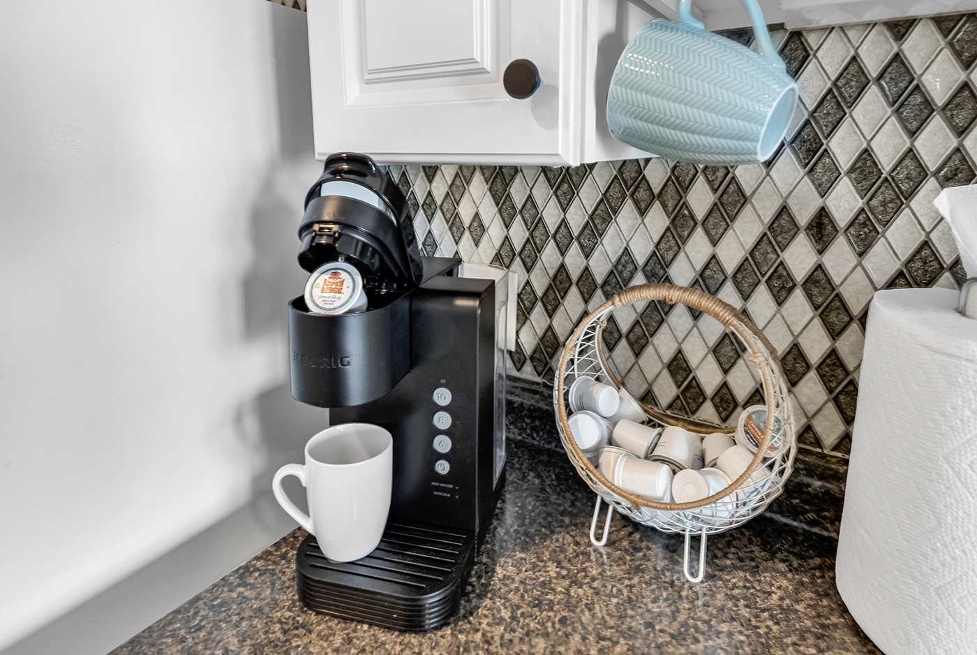 Keurig coffee maker ready to brew — pods and mugs provided