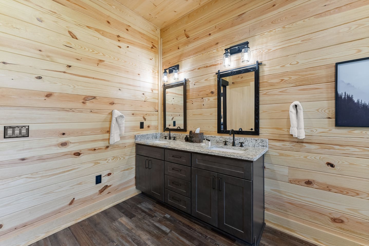 Get ready with ease at the double-sink vanity, complete with granite countertops and elegant black hardware.