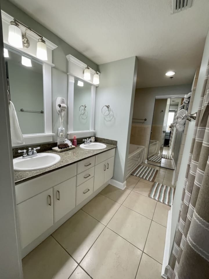 Master bath with tub, shower, and double sink vanity