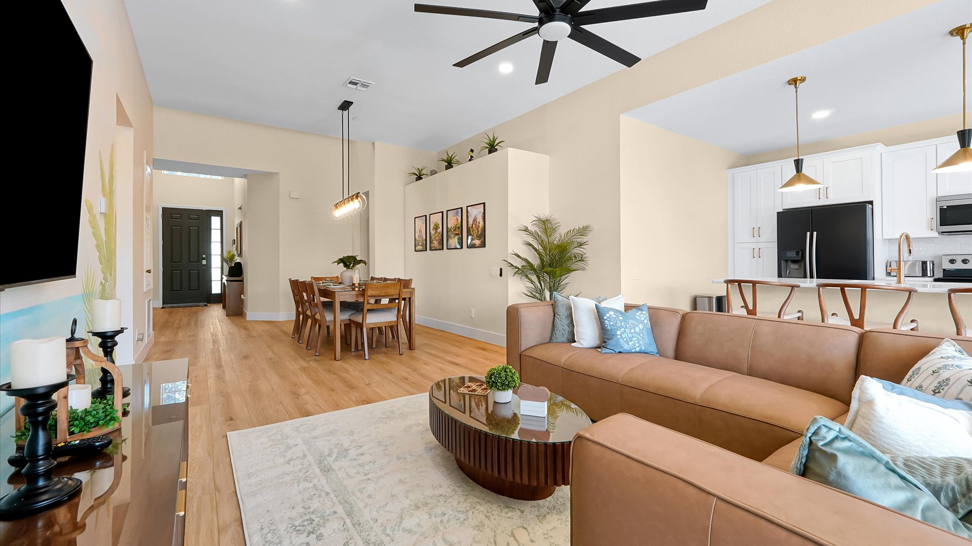 Open-Concept Living Area: Bright, spacious layout connecting the living room, dining room and fully renovated kitchen.