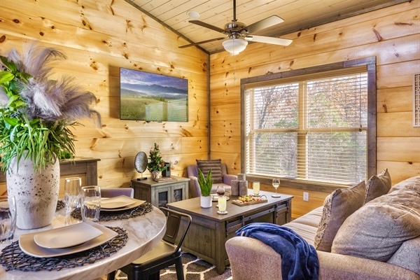 Welcome to MistyOak Cabin! Unwind in the cozy living room with comfy seating, soft throws, and mountain views. Perfect after a day of exploring the Smoky Mountains.