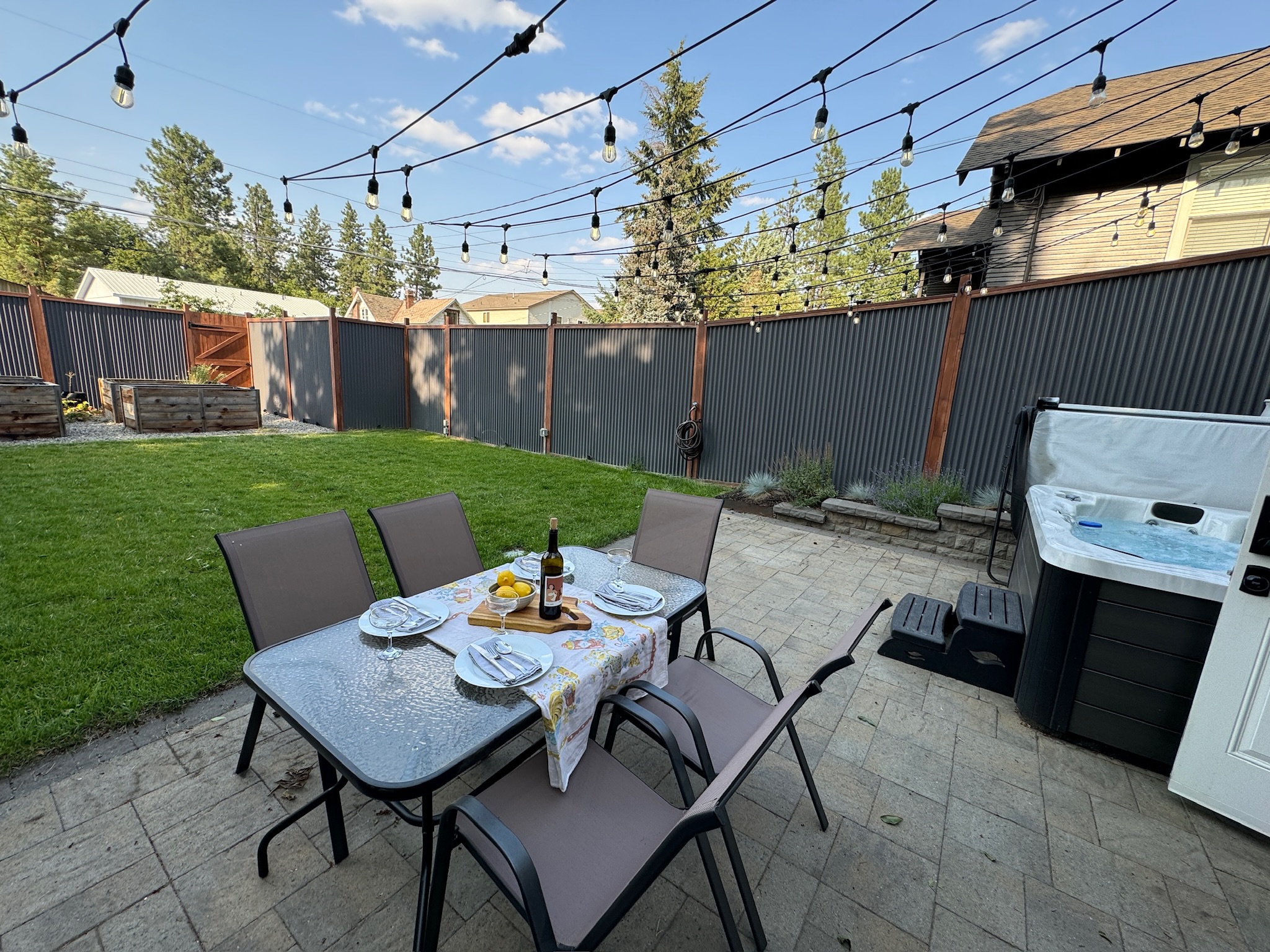 Enjoy dining outdoors on the patio in the fully fenced backyard. Then soak in the hot tub for maximum relaxation! 

Guests are encouraged to create their own patio dining experience! Please note: the photographed wine is not included in your stay :) 