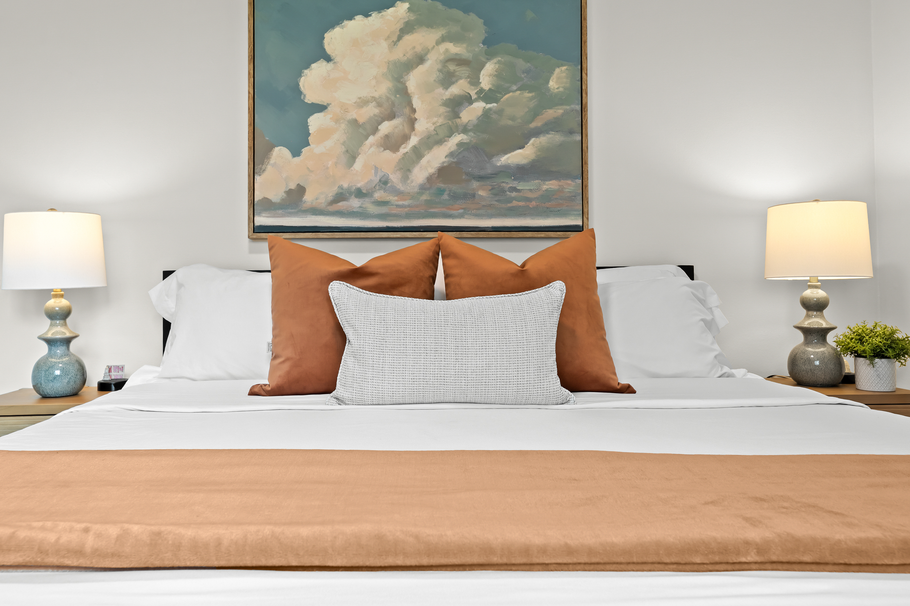 Sink into this plush king bed with luxe linens, cloud-like pillows, and calming artwork — designed for a truly restful night’s sleep.