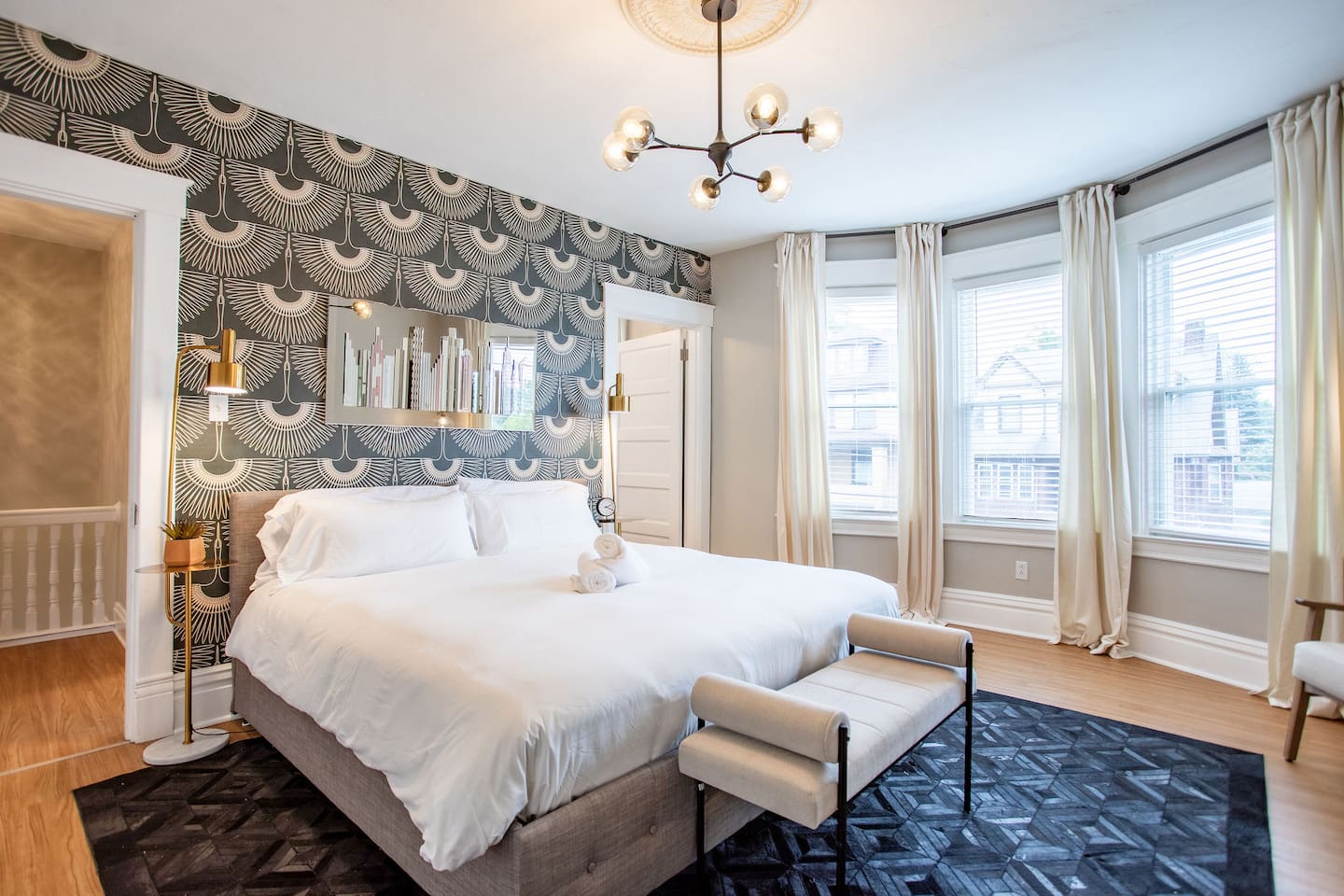 Bright and airy bedroom with large windows, allowing natural light to flood the space and offering a refreshing, open feel.
