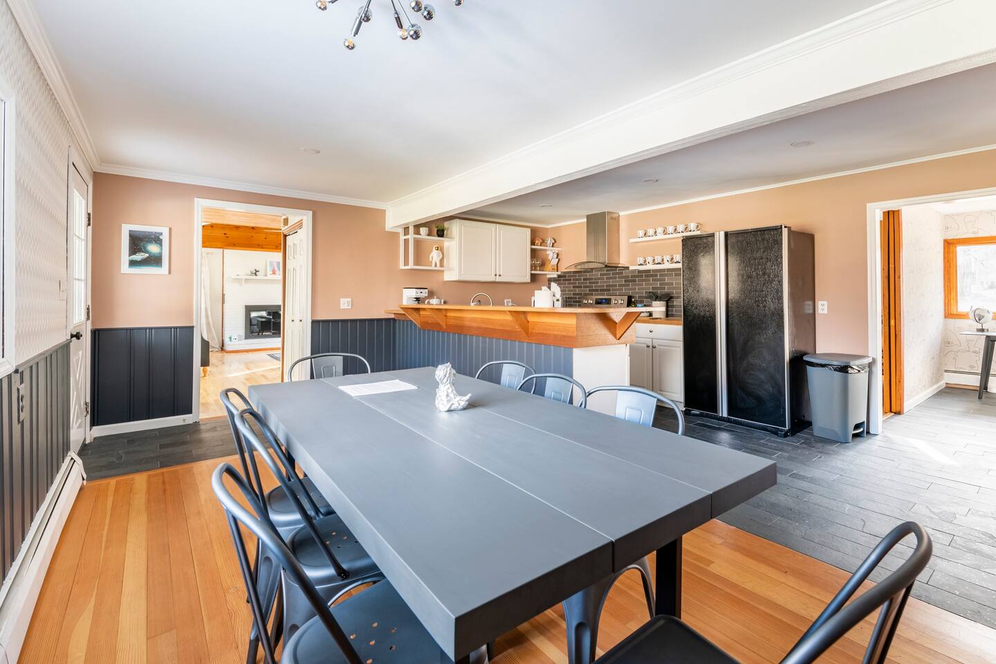Dining room table in viewing kitchen, living room and office area.