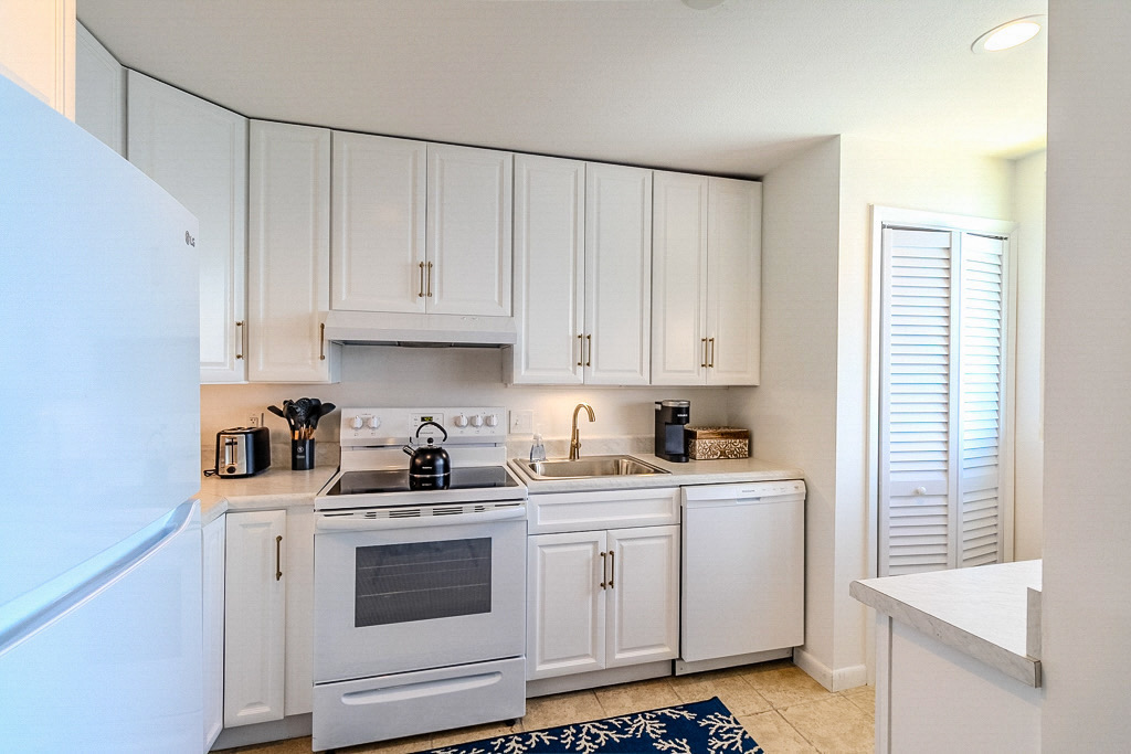 Modern, updated kitchen with everything you need to enjoy your stay, including a washer/dryer behind the slatted doors.
