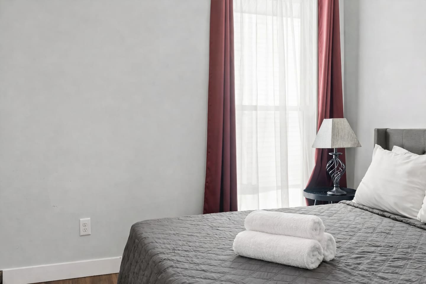 Detailed bed view highlighting plush pillows, quilted bedding, and a calm, neutral design.