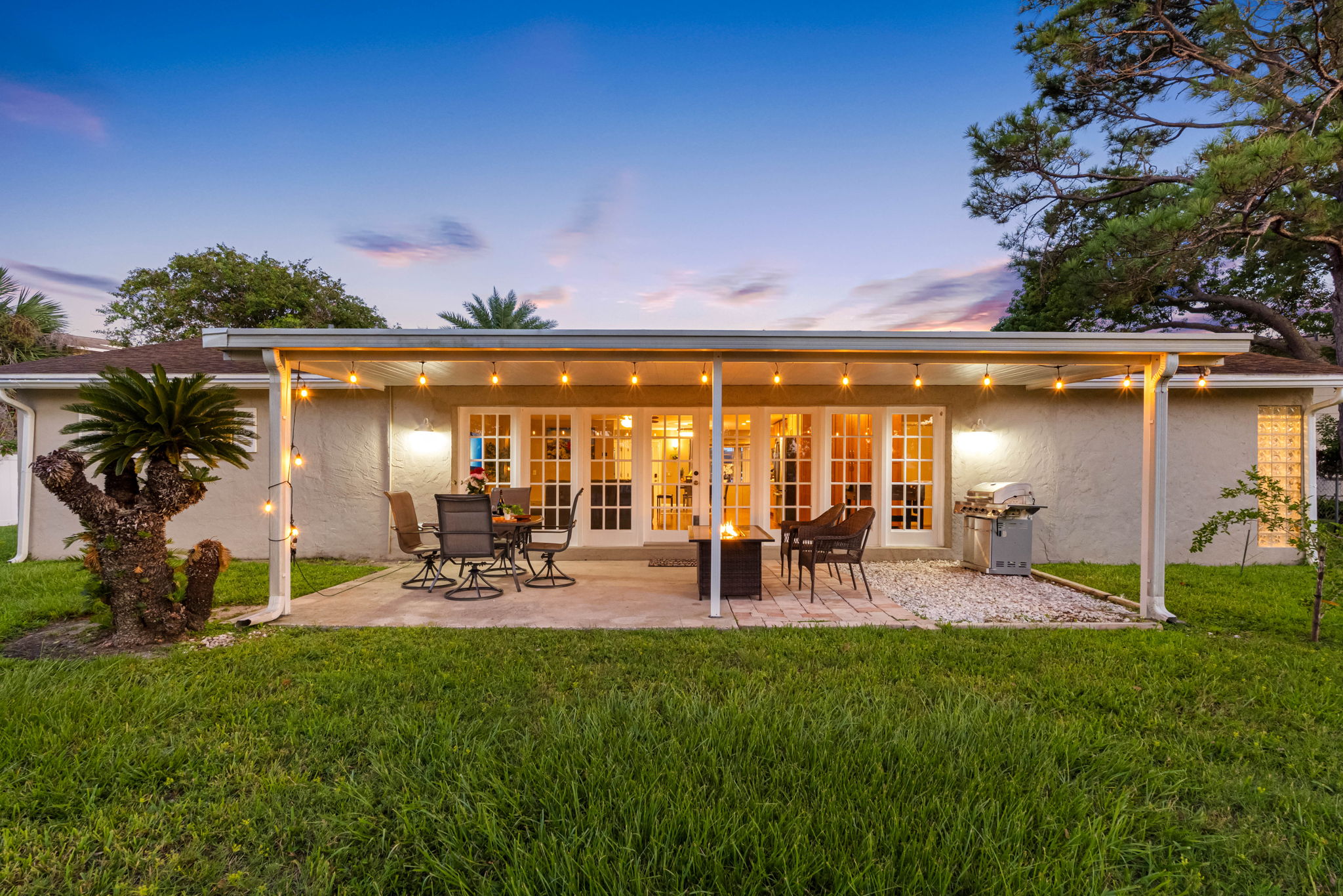 With a spacious table and comfortable chairs under a covered roof, this patio invites you to savor meals outdoors while protected from the elements.