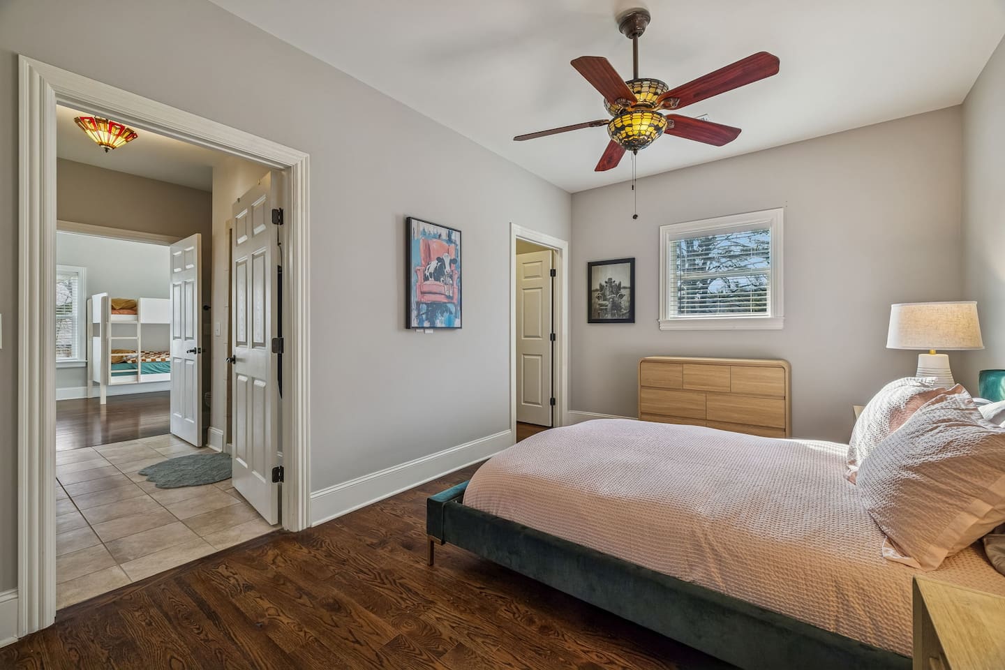 Green Bed Bedroom with queen bed and view of upstairs bathroom.