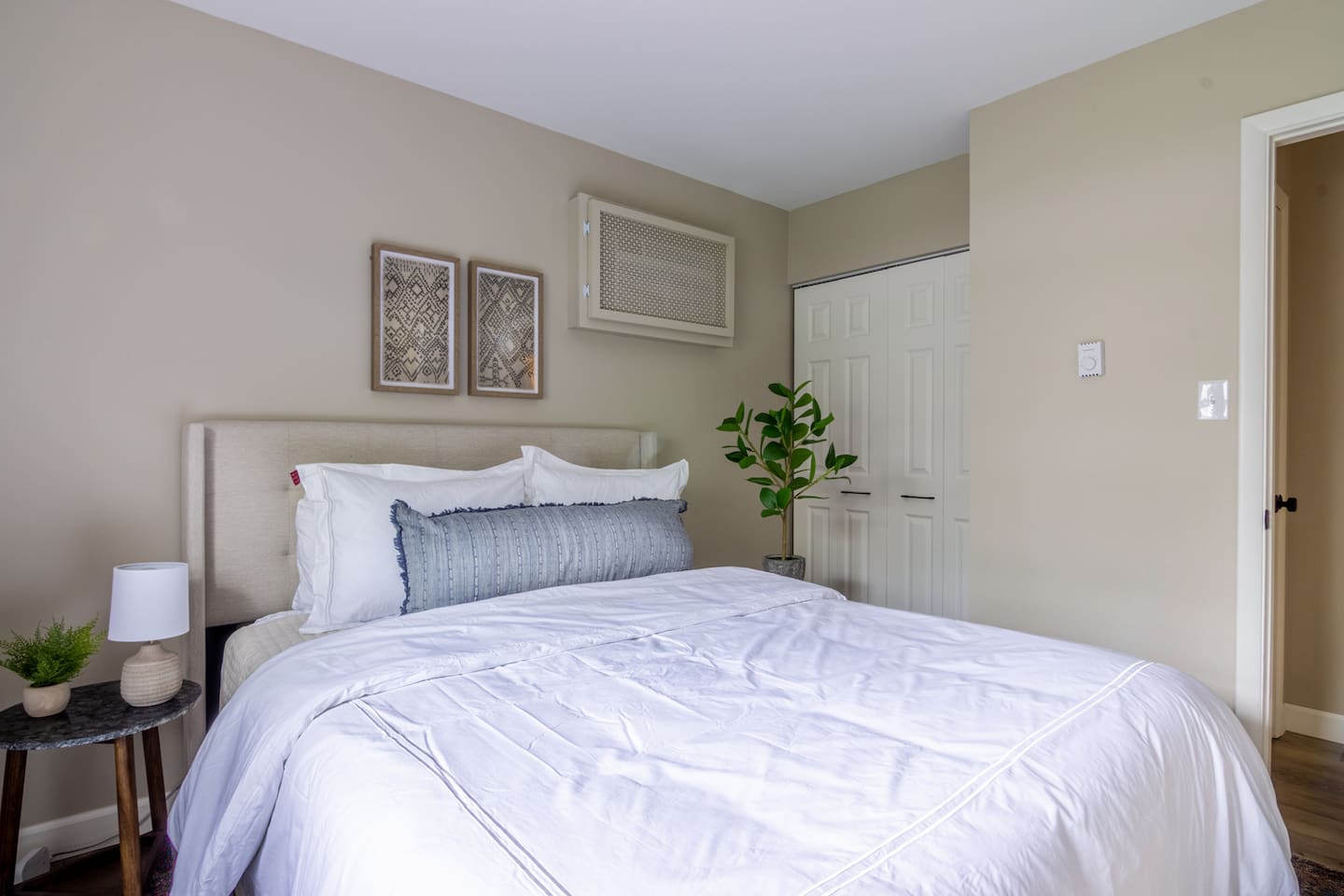 Soft neutrals and greenery bring an easy, restful energy to this quiet corner of the home.