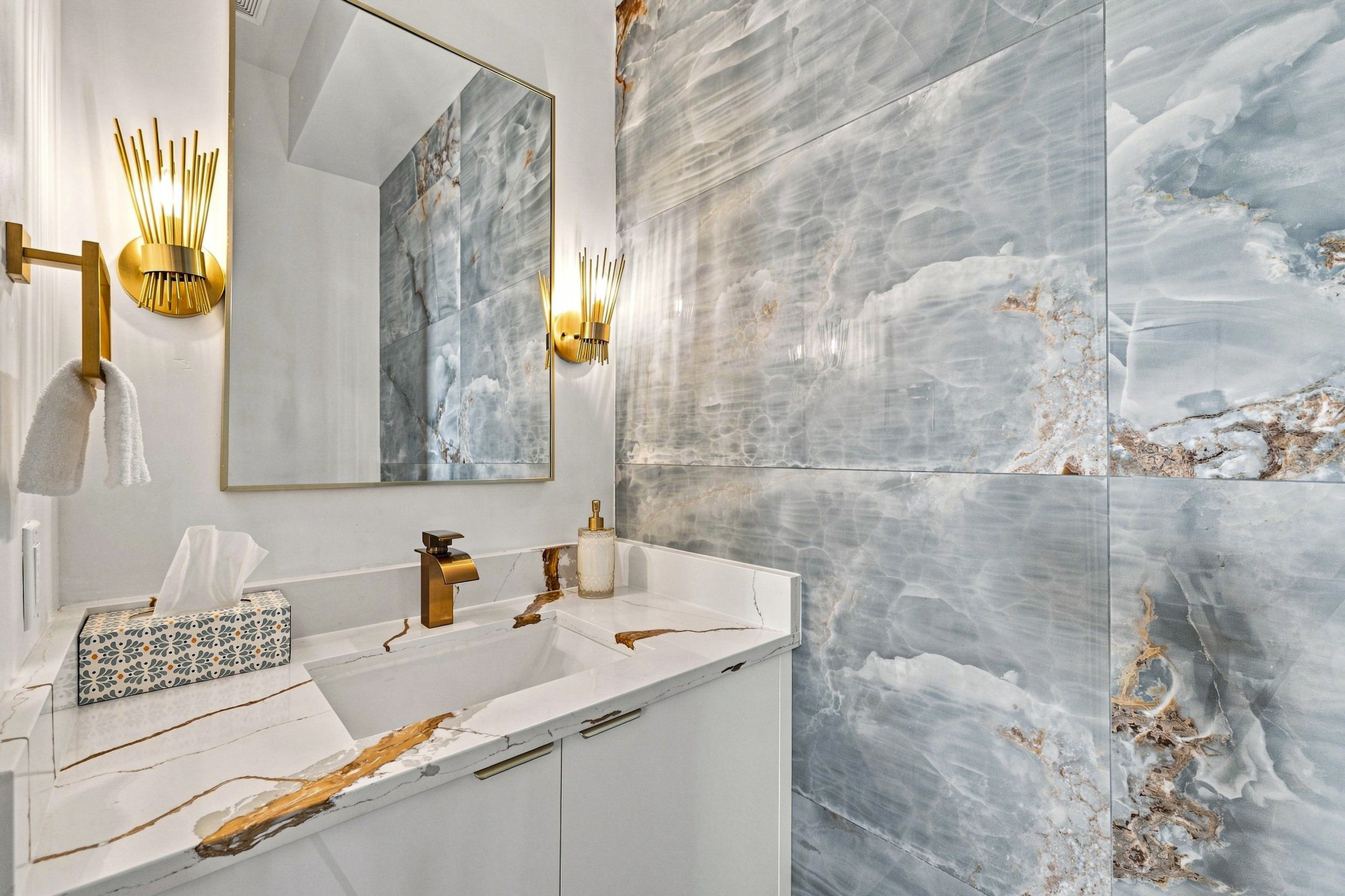Stunning marble accents and chic lighting create a delightful retreat!