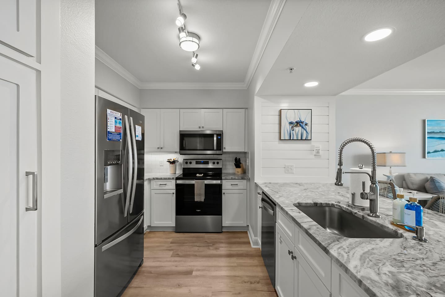 Whip up meals in this fully equipped kitchen featuring stainless steel appliances, beautiful countertops, and coastal charm—perfect for enjoying beachside breakfasts or sunset dinners at your Panama City Beach getaway.