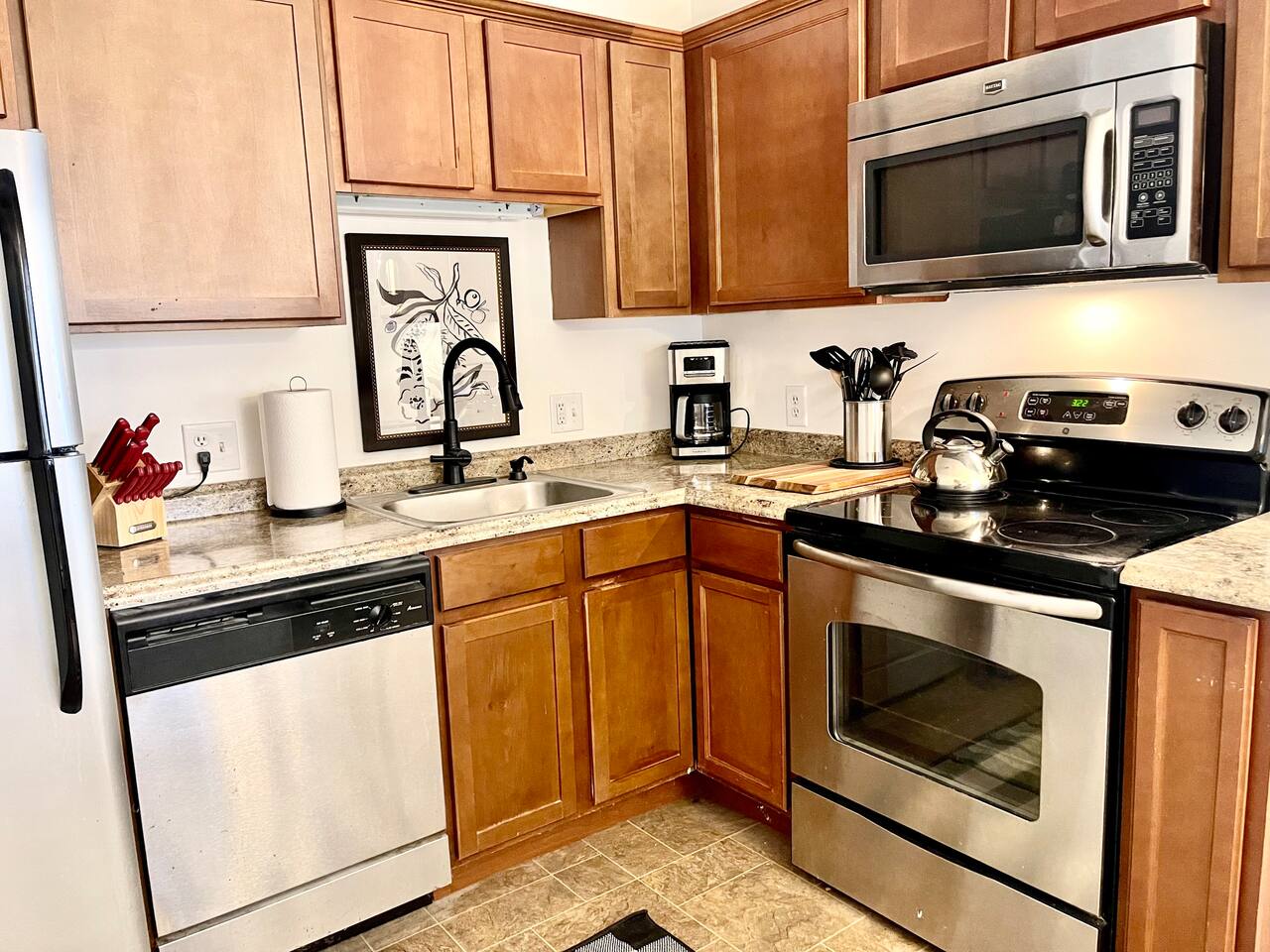 This bright, functional kitchen features SS appliances, a full set of cooking essentials, granite-style counters, and modern decor. Whether you're preparing a quick breakfast or a full dinner, this space is equipped to make your stay comfortable.