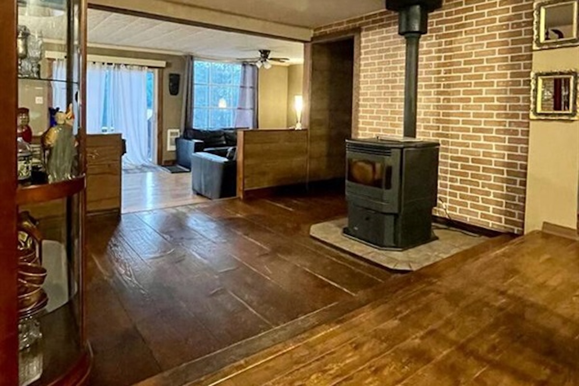Open living area with wood stove and rustic finishes