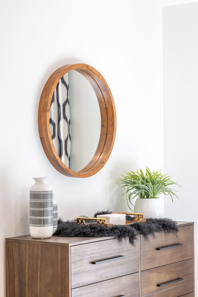 Bedroom 2 features a spacious dresser with ample storage, styled with warm wood tones and thoughtful décor. Ideal for unpacking and settling in, this piece adds both function and a polished, hotel-inspired feel to the room.