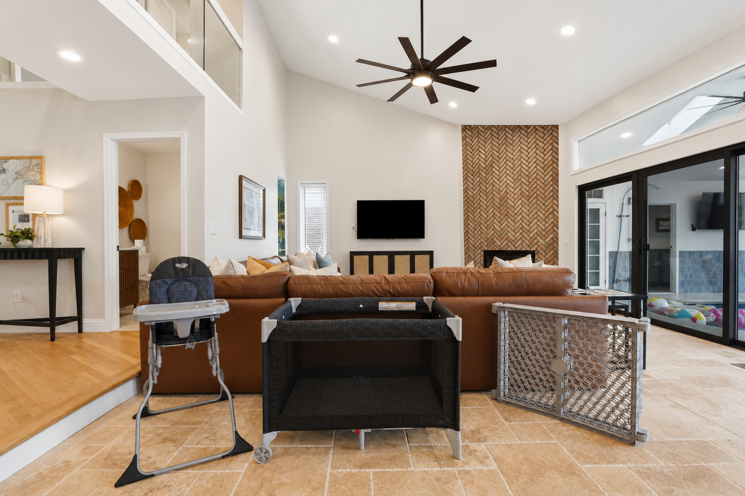 Modern open-concept living room with high ceilings, stylish seating, and seamless indoor-outdoor flow. Bright, spacious, and perfect for relaxing or entertaining.