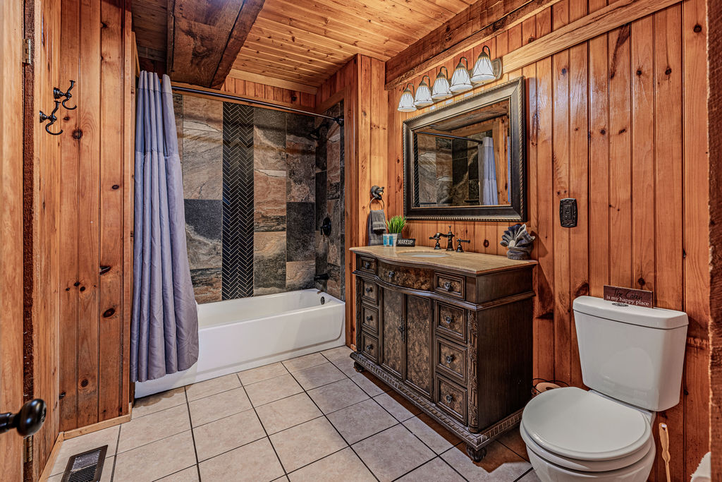 Full bathroom with tub and vanity lighting