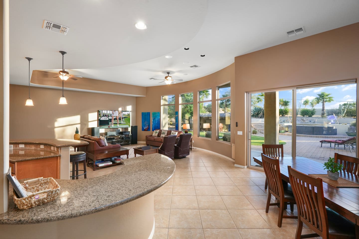 Open-concept layout showcasing the living room’s flow into the kitchen and dining spaces