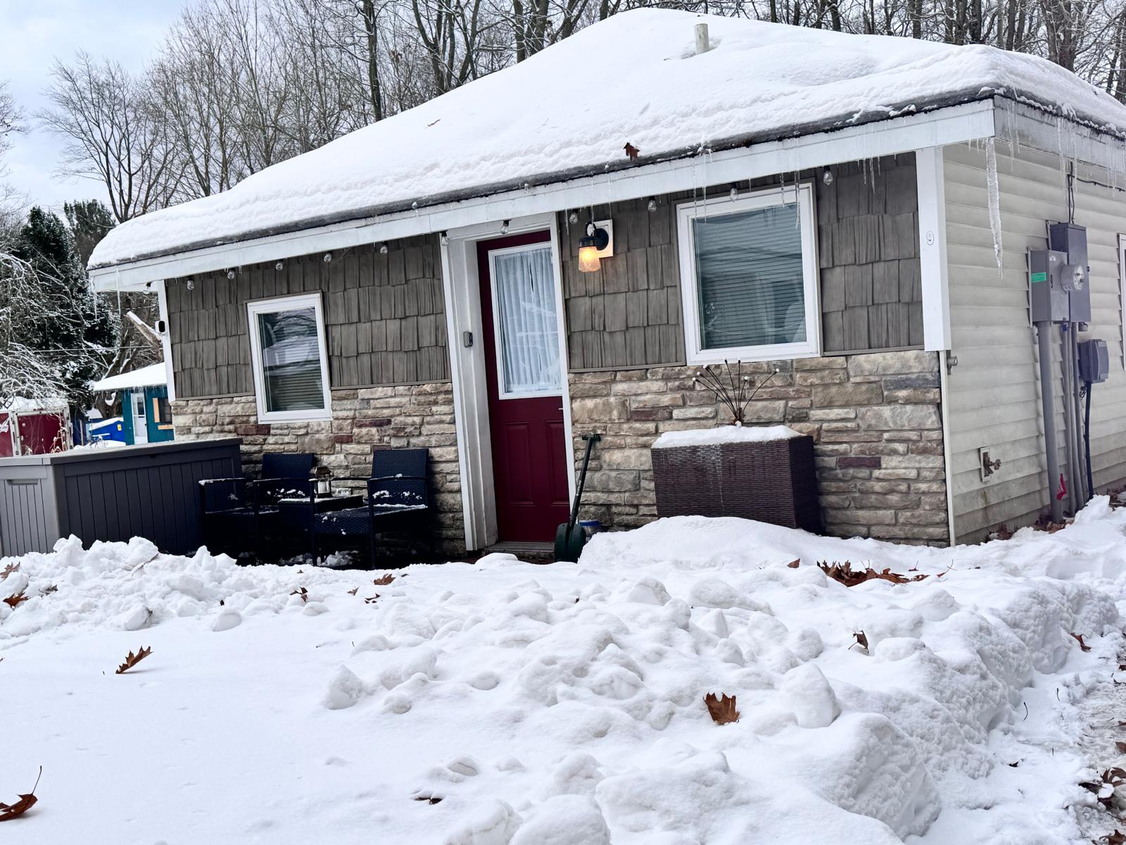 Charming snow covered entrance welcoming you to your cozy winter getaway