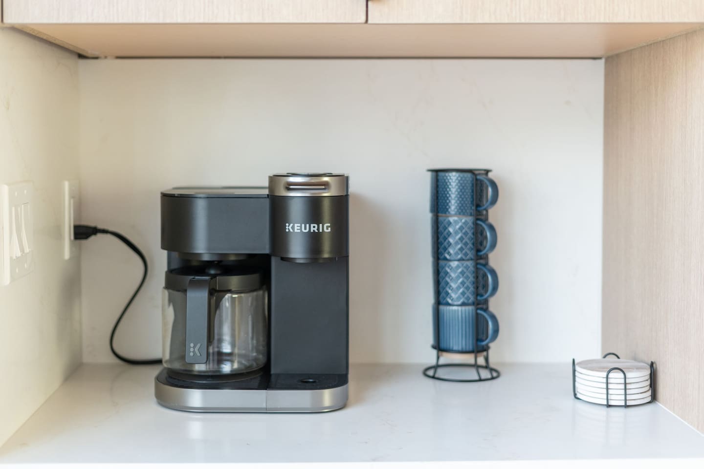 Coffee station with Keurig machine, mugs, and everything you need for your morning brew.