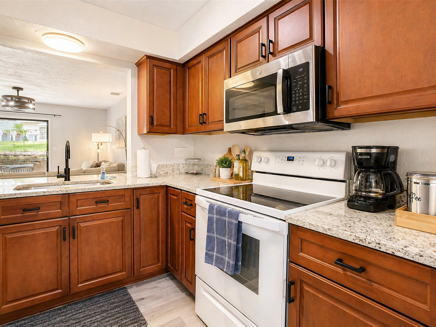 kitchen with trash compactor dish washer and large fridge with freezer and water dispenser