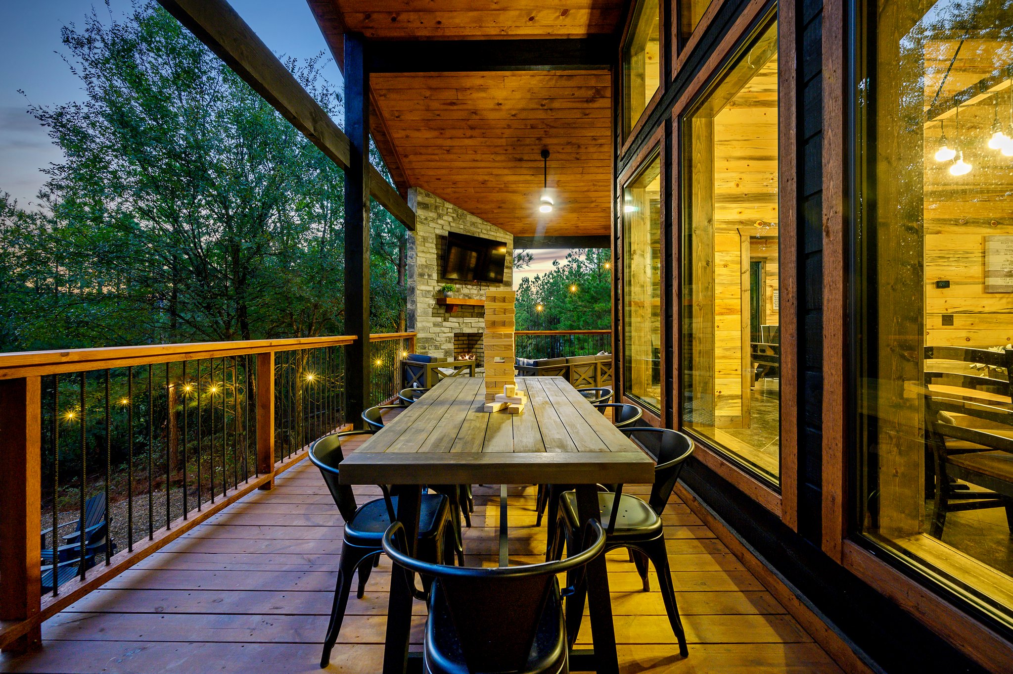 The ultimate evening hangout: cozy deck seating and wooded serenity.