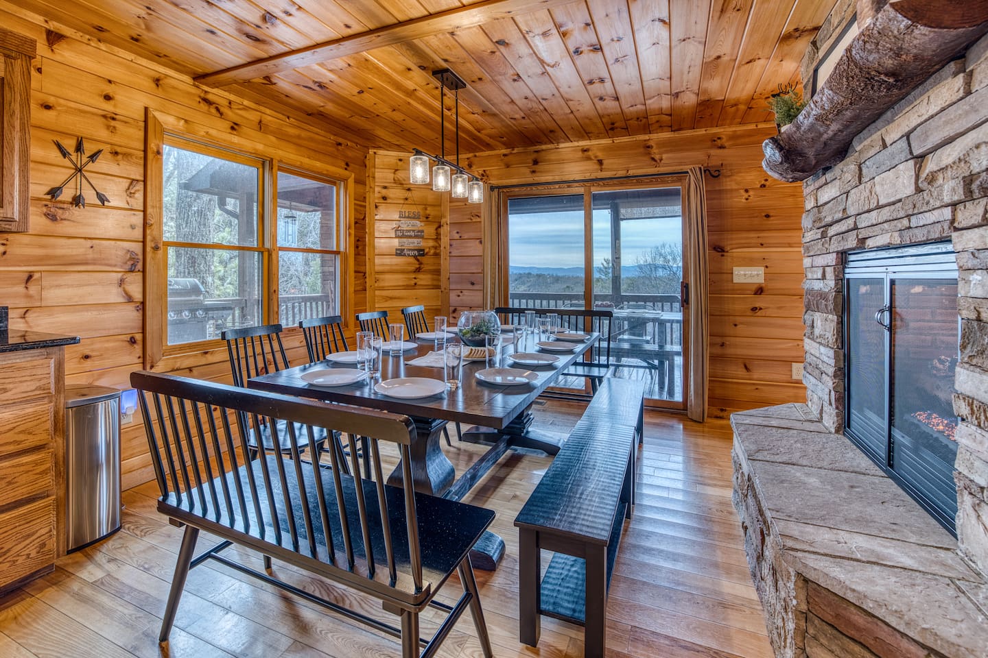 Dining area right off the fully-stocked kitchen that has seating for 12, with double-sided fireplace between dining area and living room.